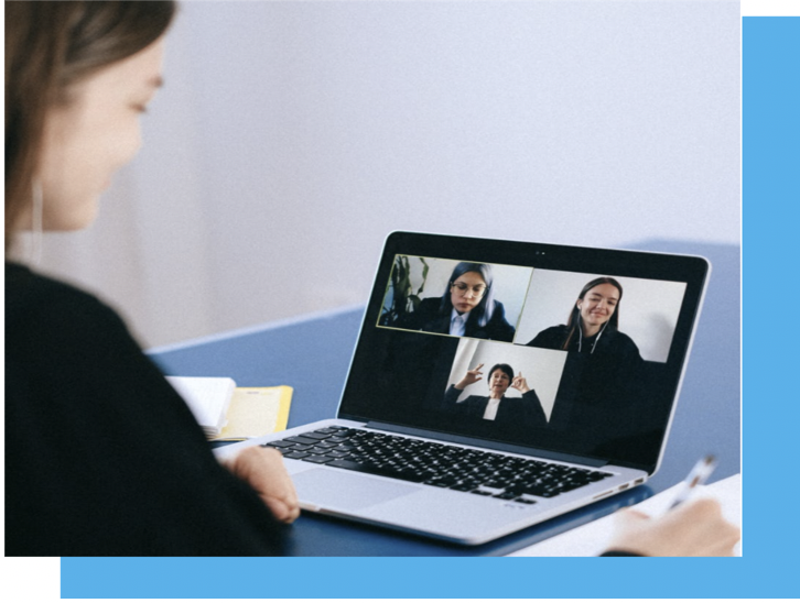 girl looking at computer with three people on video call